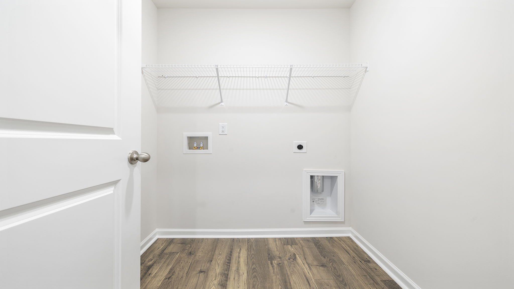 Walk-in laundry room with shelving.