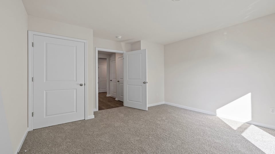 Bedroom with window and carpet.