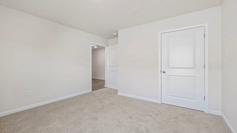 Bedroom with window and carpet.