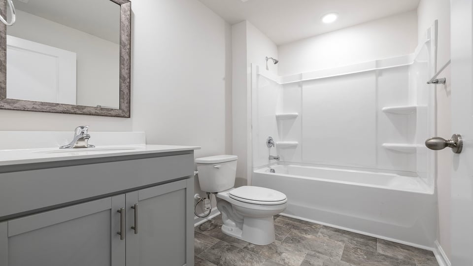 Hall bathroom with vanity and combination shower / tub.