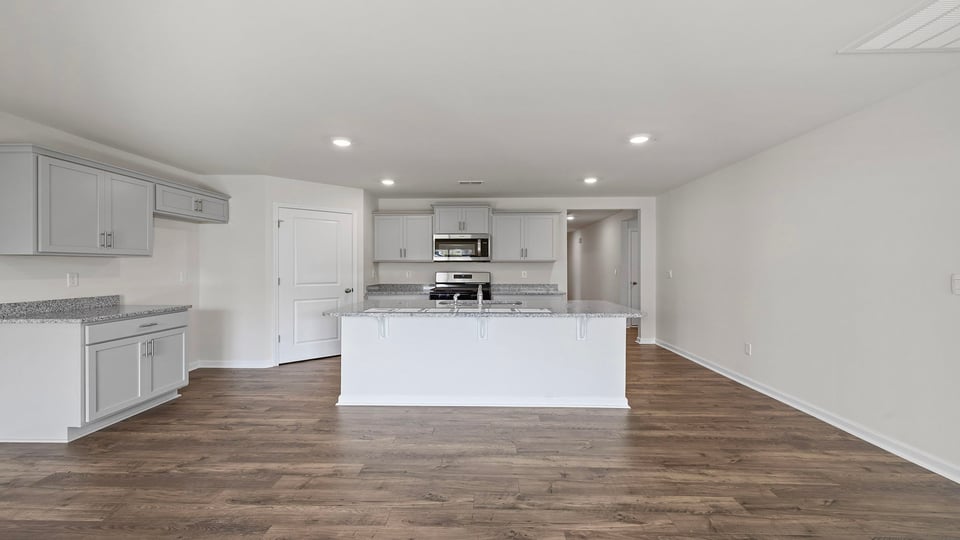 View of open kitchen with recessed lighting.