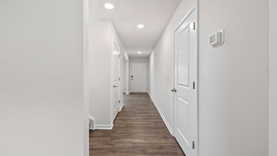 Hallway into home with view of rooms.