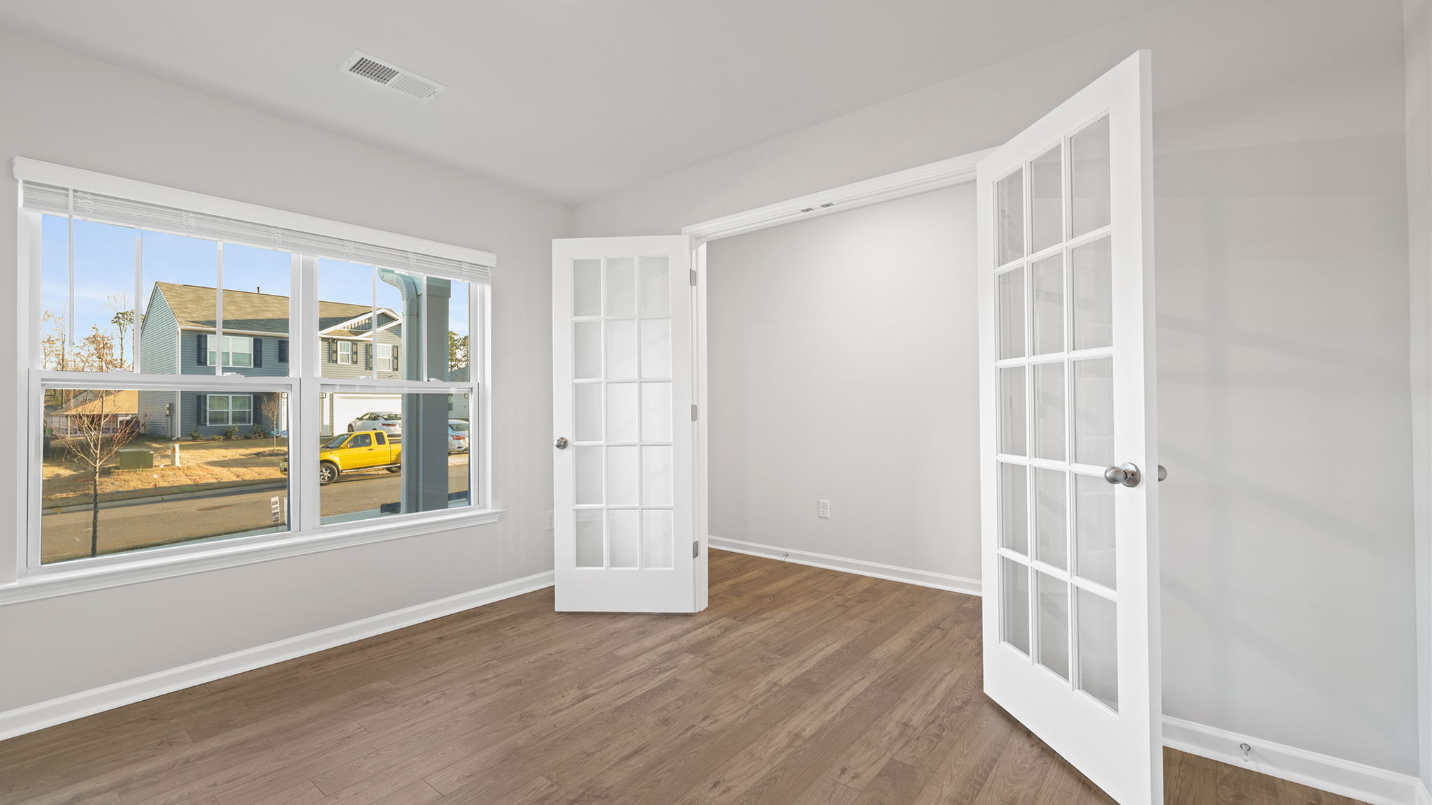 Study accented with large window and French doors.