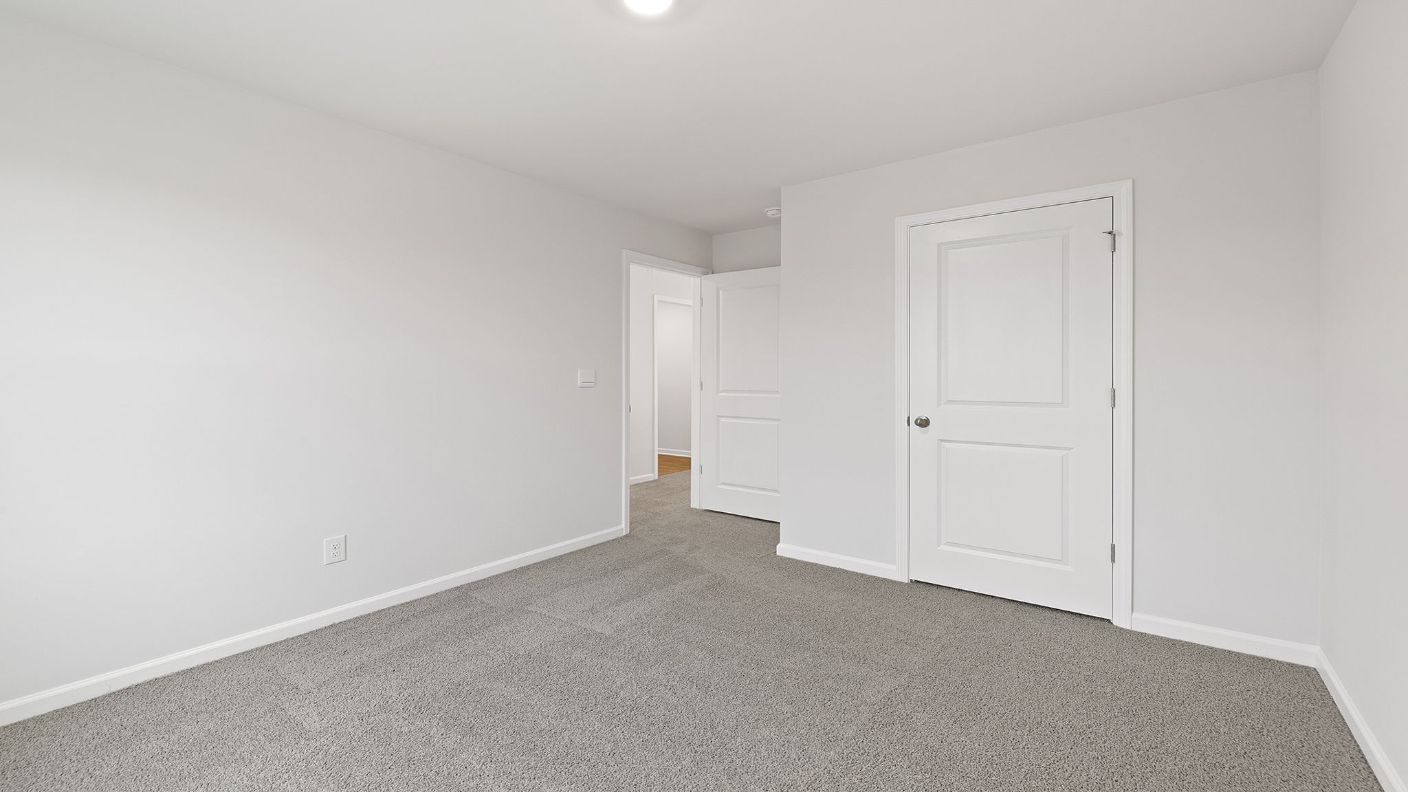 Bedroom with window and carpet.