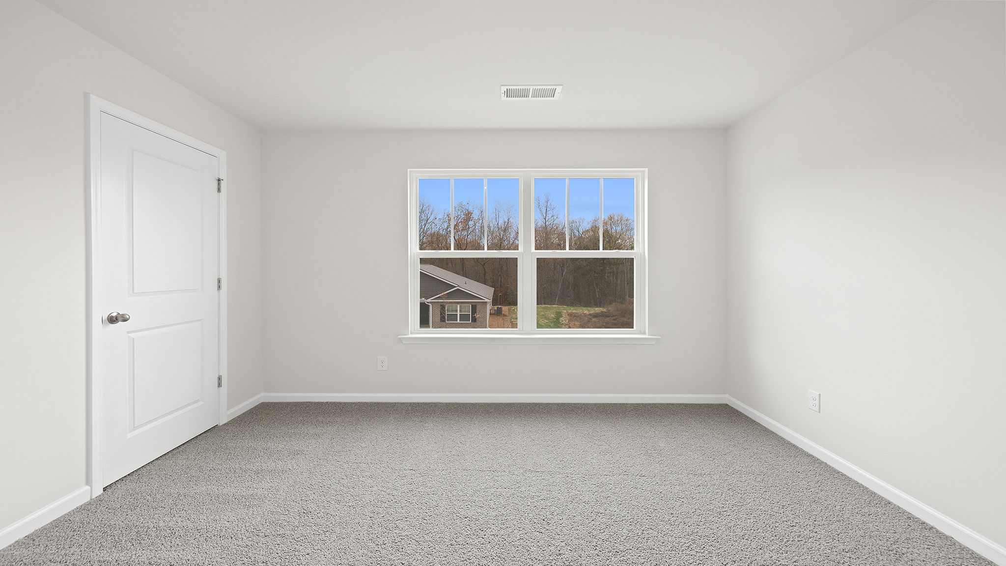 Bedroom with window and carpet.