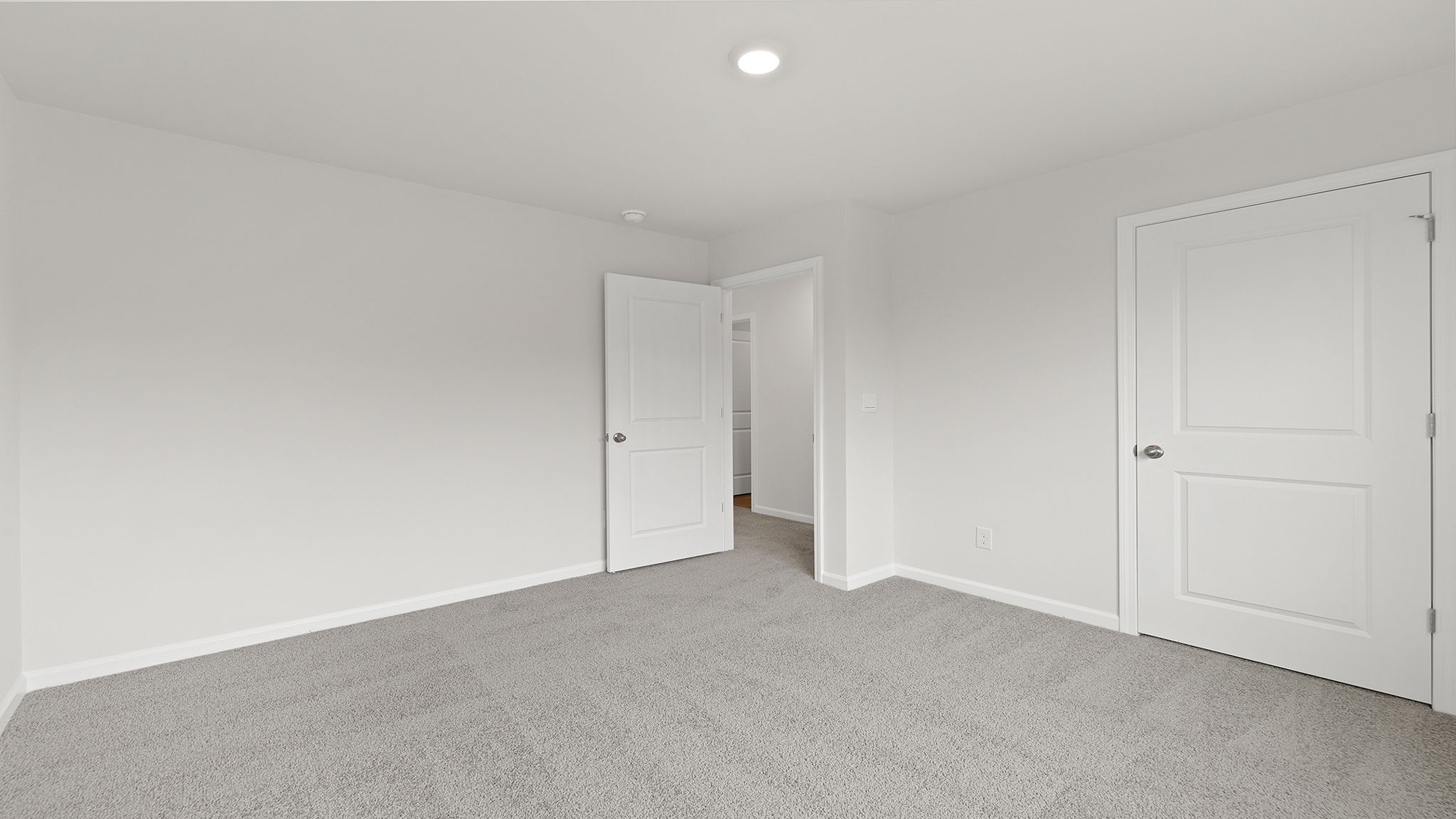 Bedroom with window and carpet.