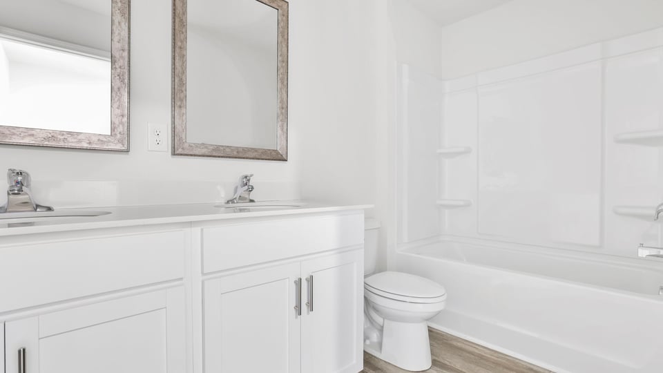 Hall bathroom with vanity and combination shower / tub.