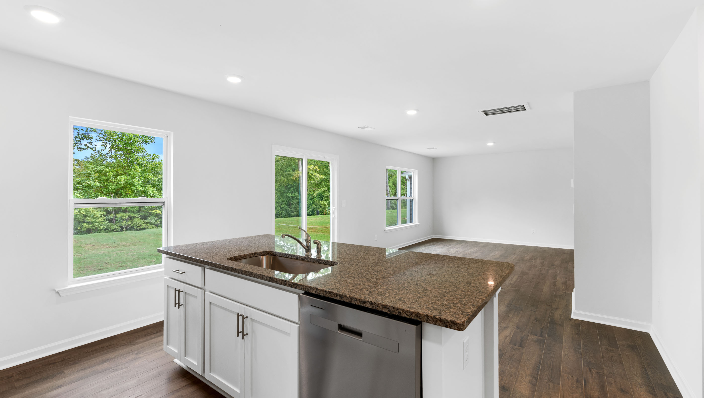 Kitchen and island with granite counter tops.