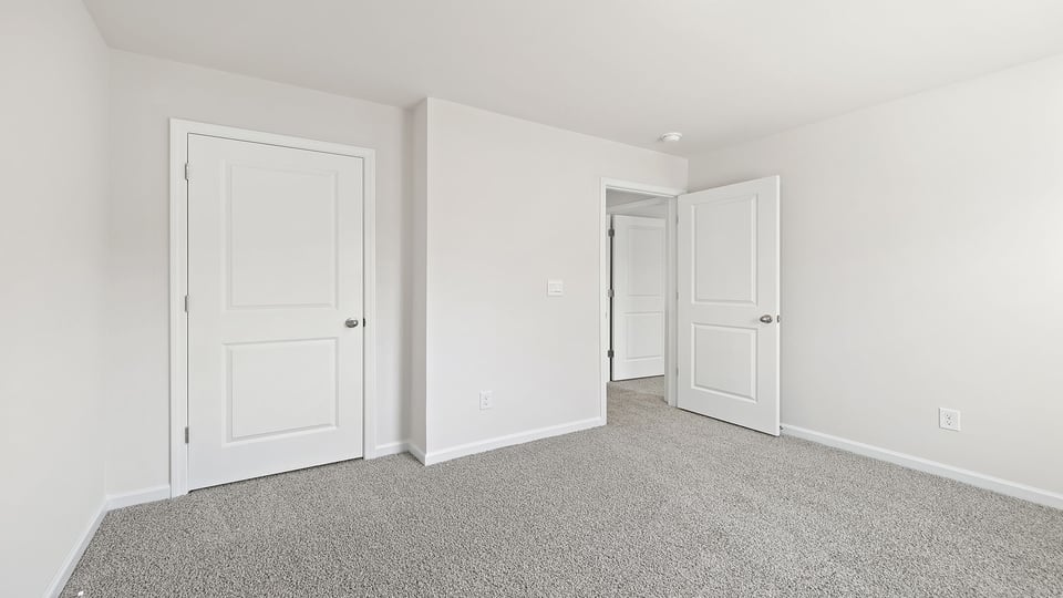 Bedroom with carpet and window.