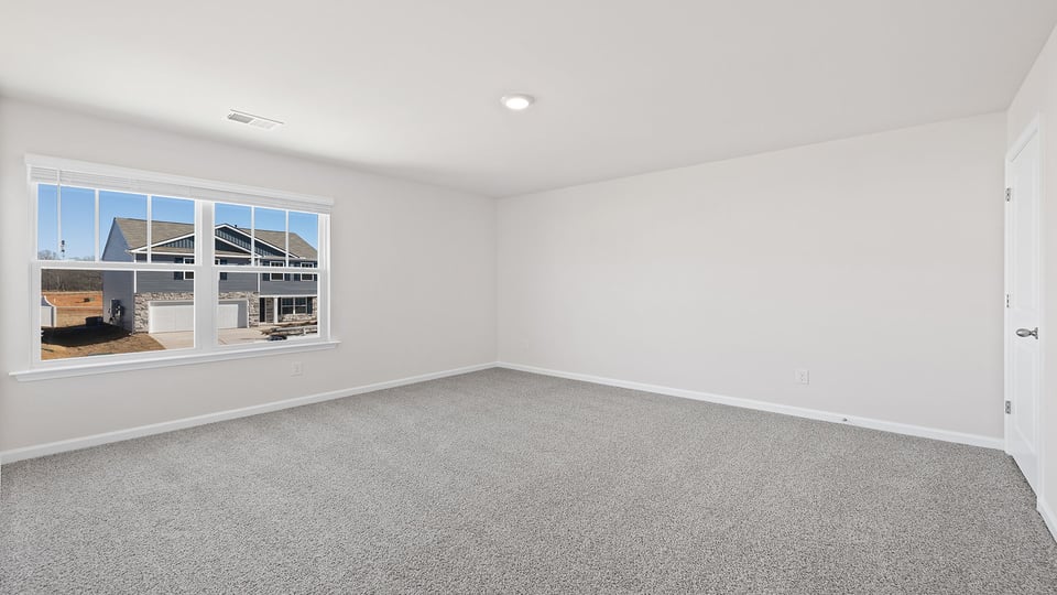 Bedroom with carpet and window.