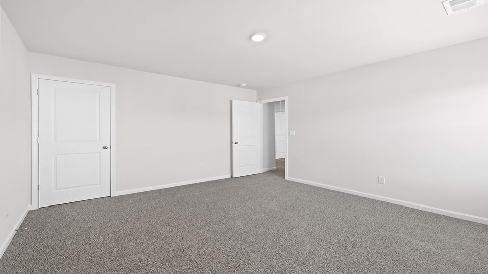 Bedroom with carpet and window.