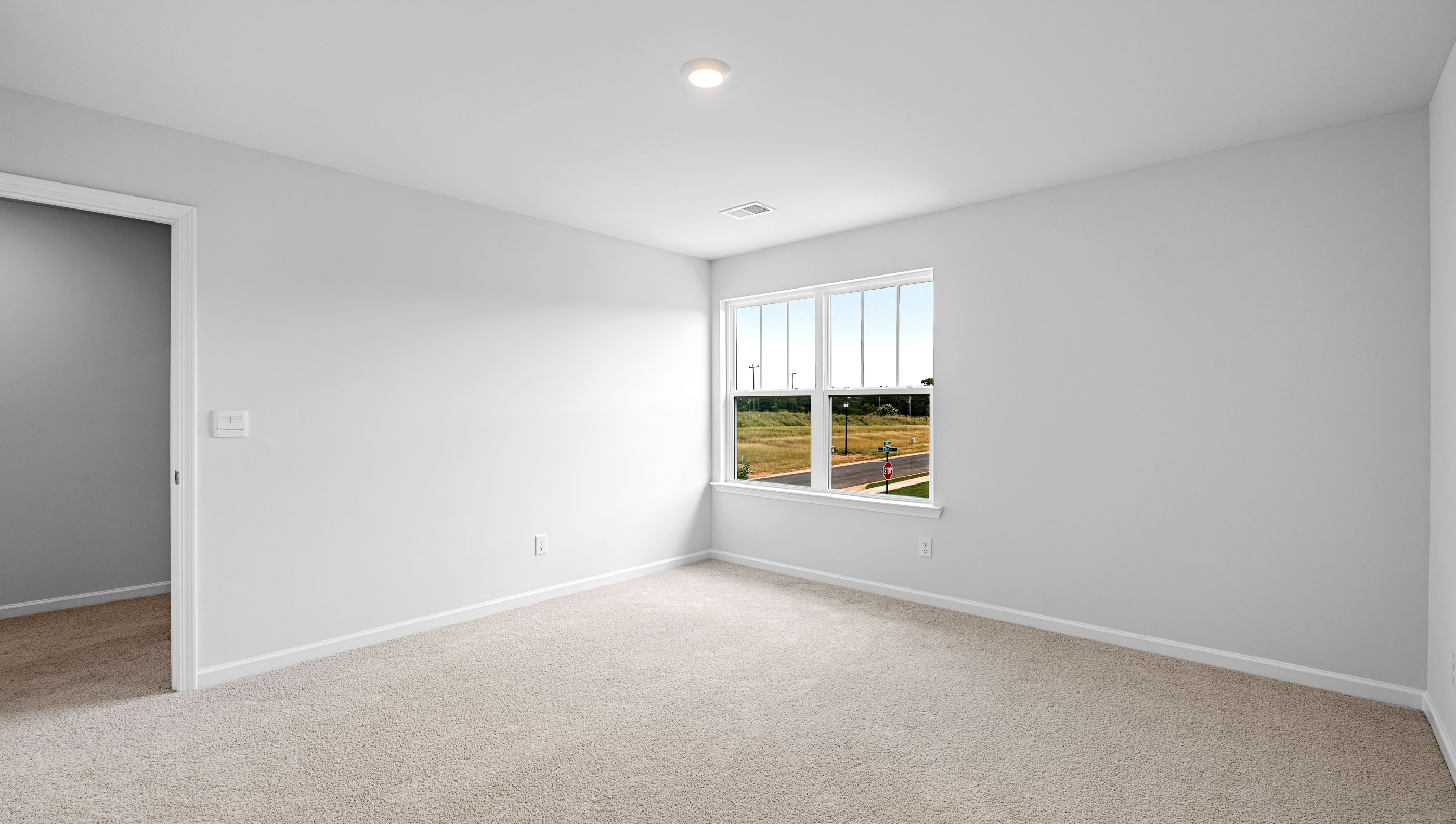 Bedroom with carpet and window.