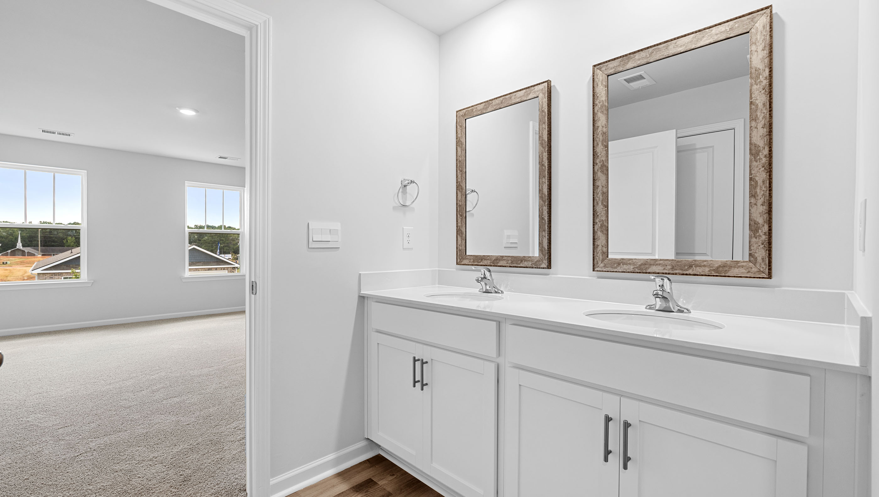Primary bathroom with double sink and mirrors.