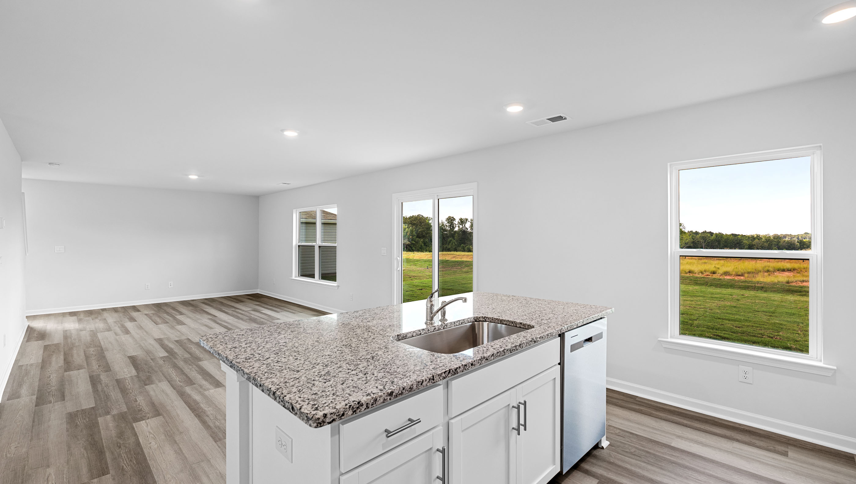 View from kitchen of the windows and family room.