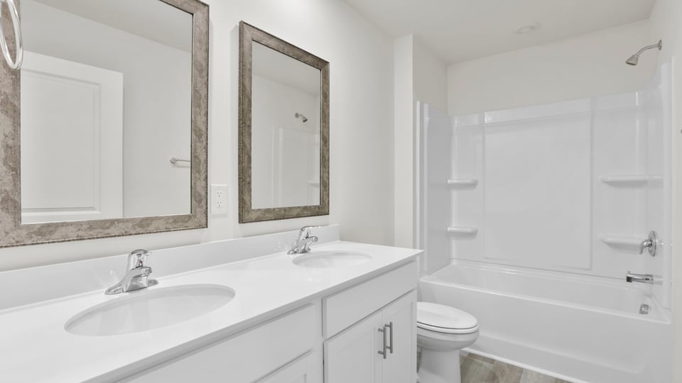 Bathroom with vanity sinks.