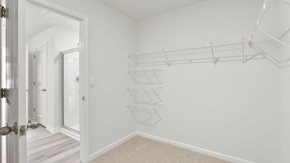 Closet with carpet and shelf.