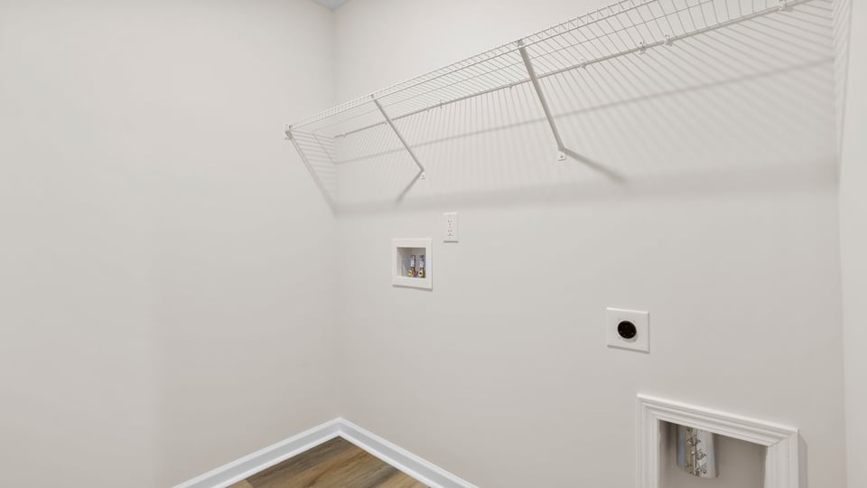 Laundry room with hanging storage racks.