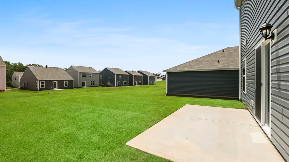 Back exterior of home with patio.