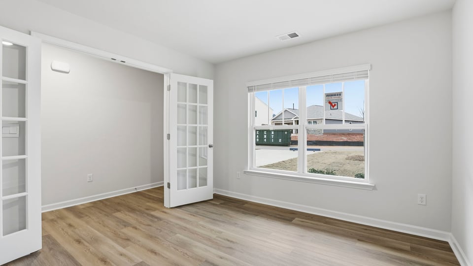 Study with large window and French doors.