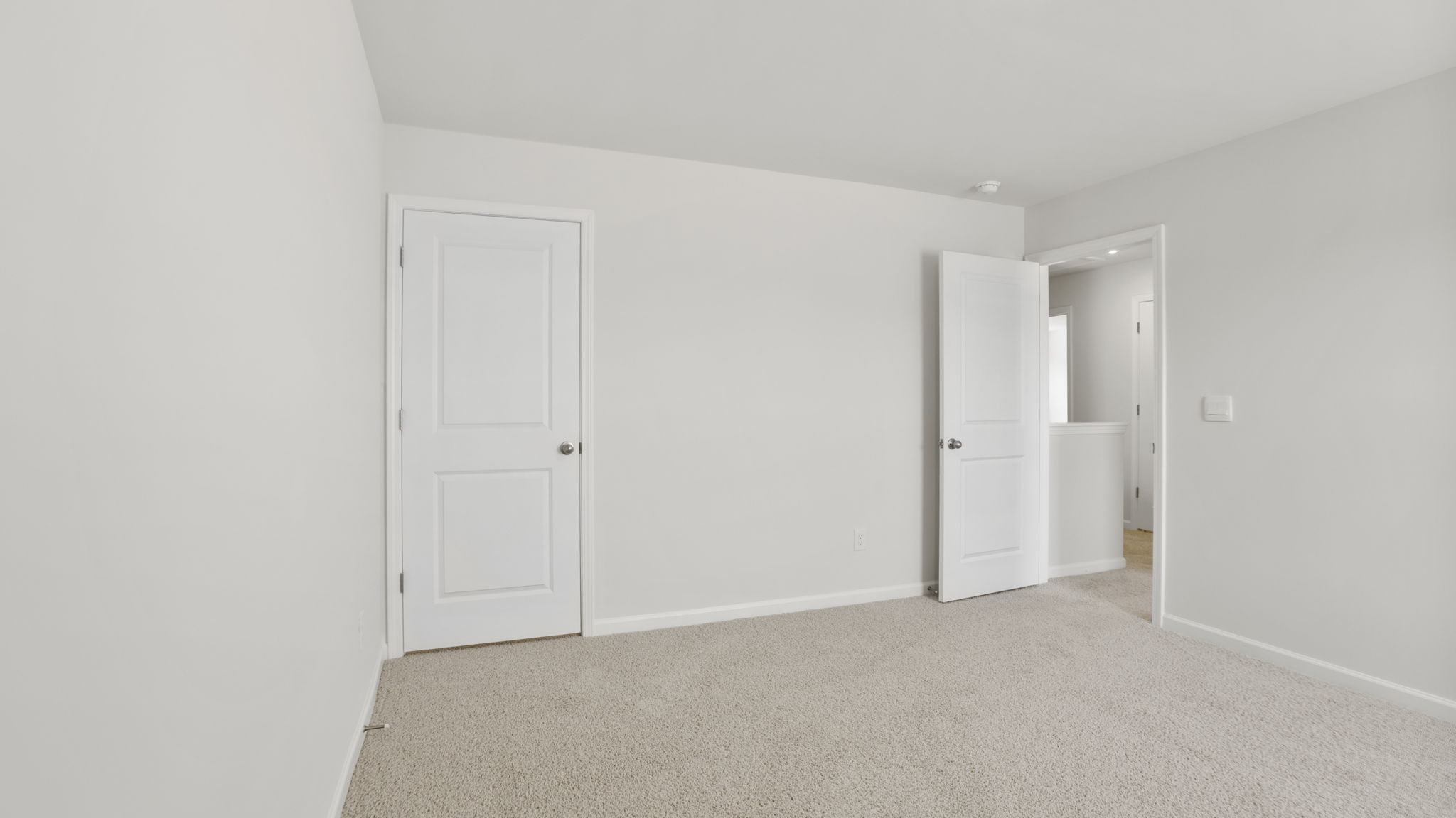 Bedroom with carpet and windows.