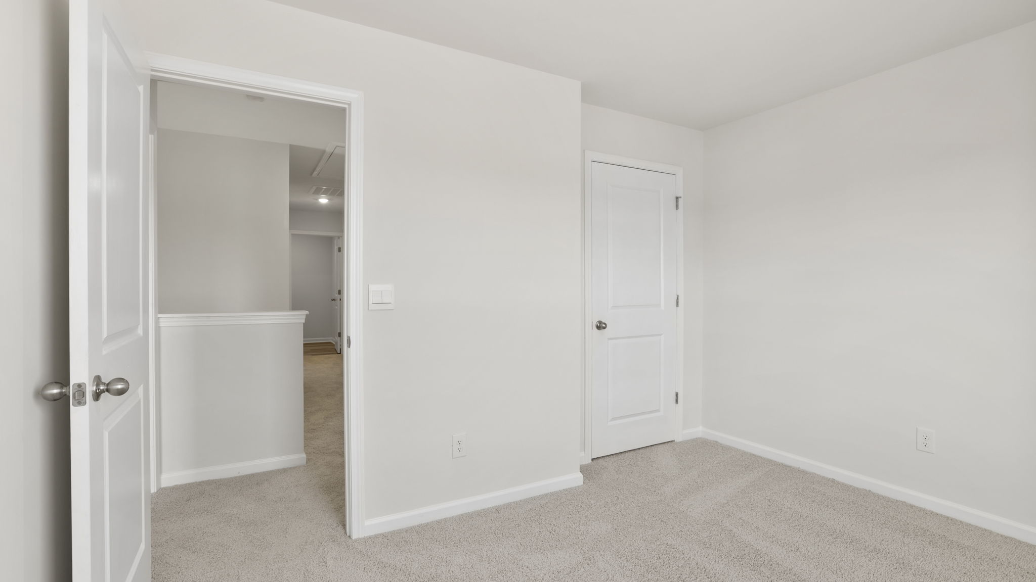 Bedroom with carpet and windows.