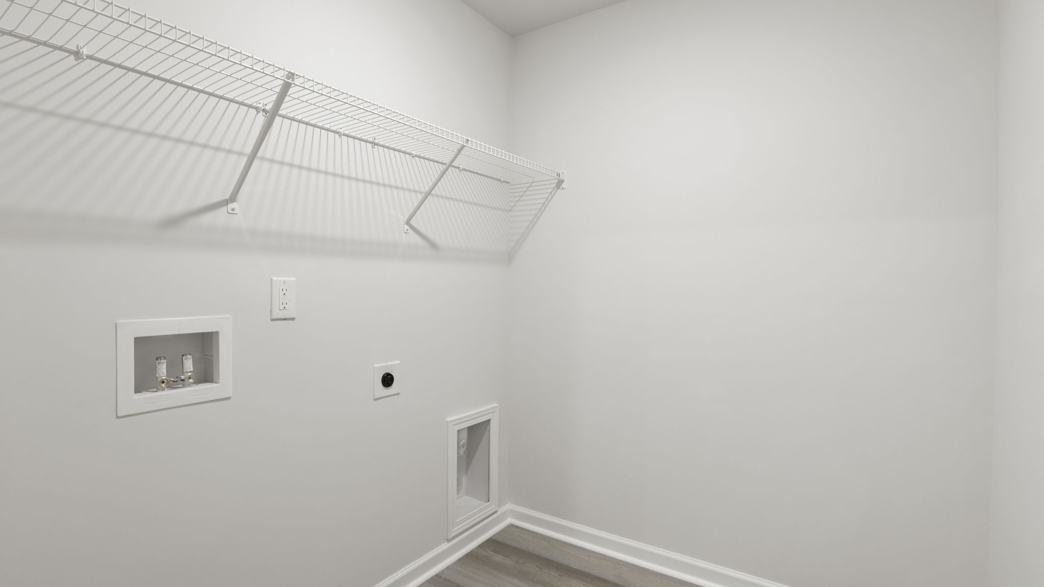 Laundry room with hanging storage racks.