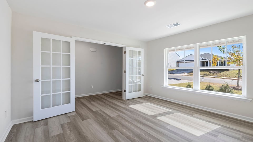 Study is accented with large window and French doors.