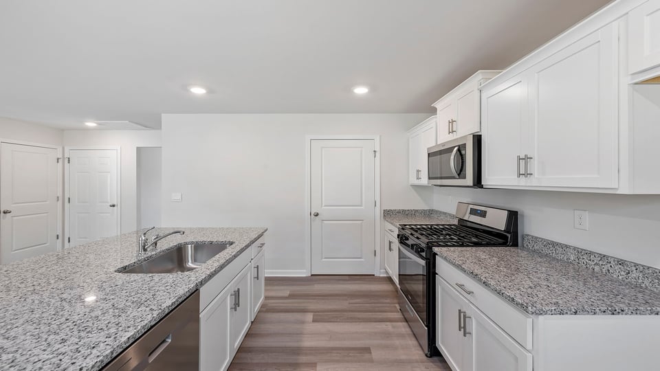 Quartz countertops and white cabinetry.
