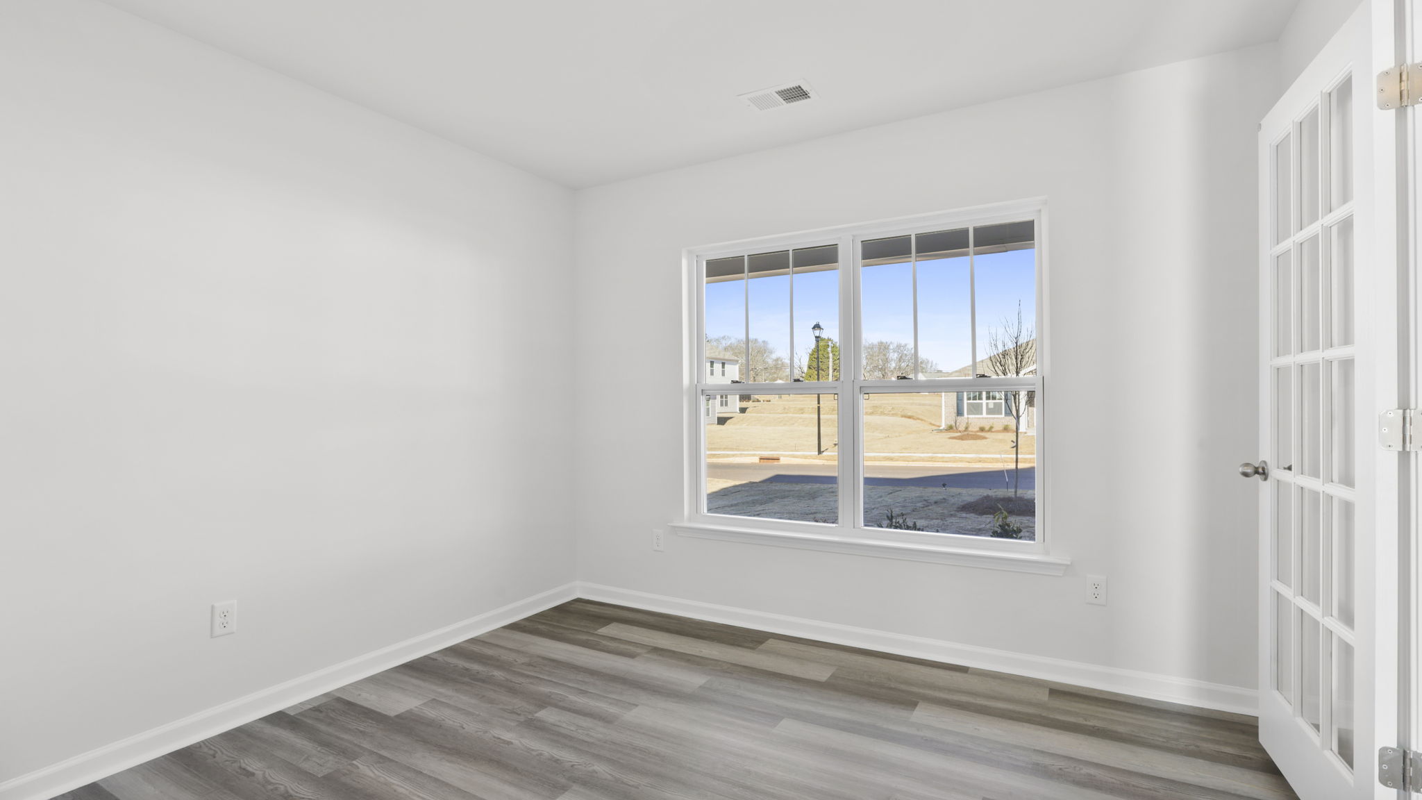 Study located at front of home with window.