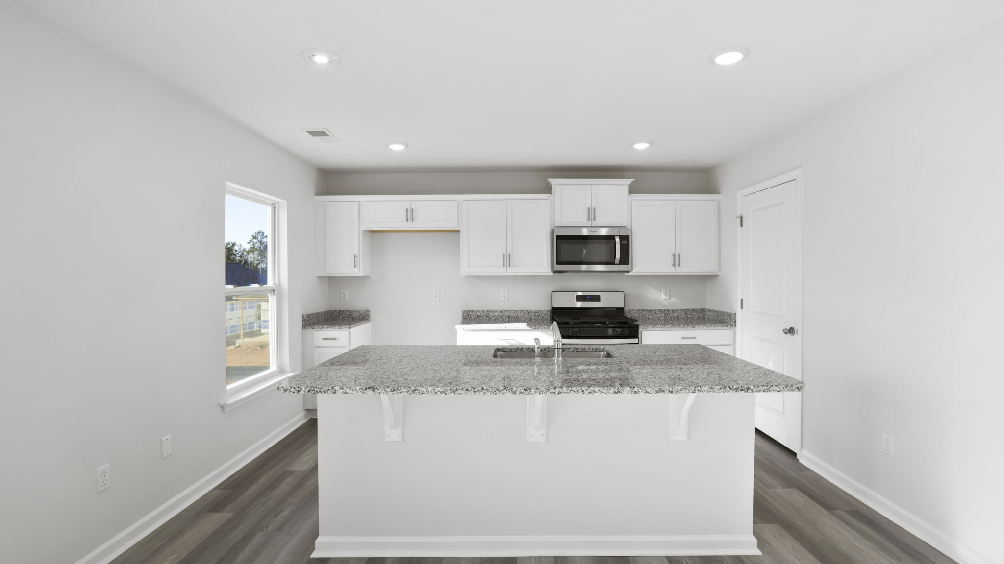 Kitchen and island with quartz counter tops.