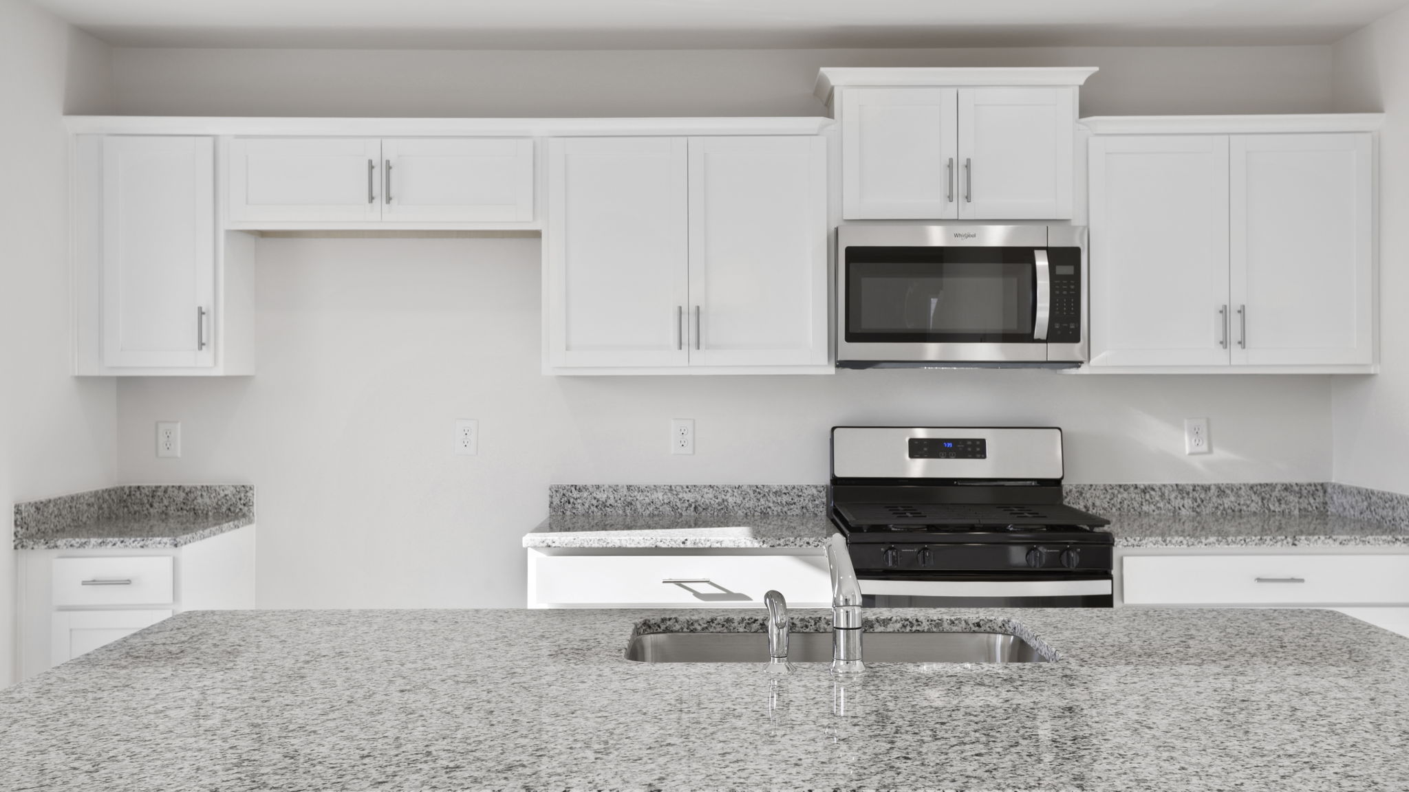 Kitchen and island with quartz counter tops.