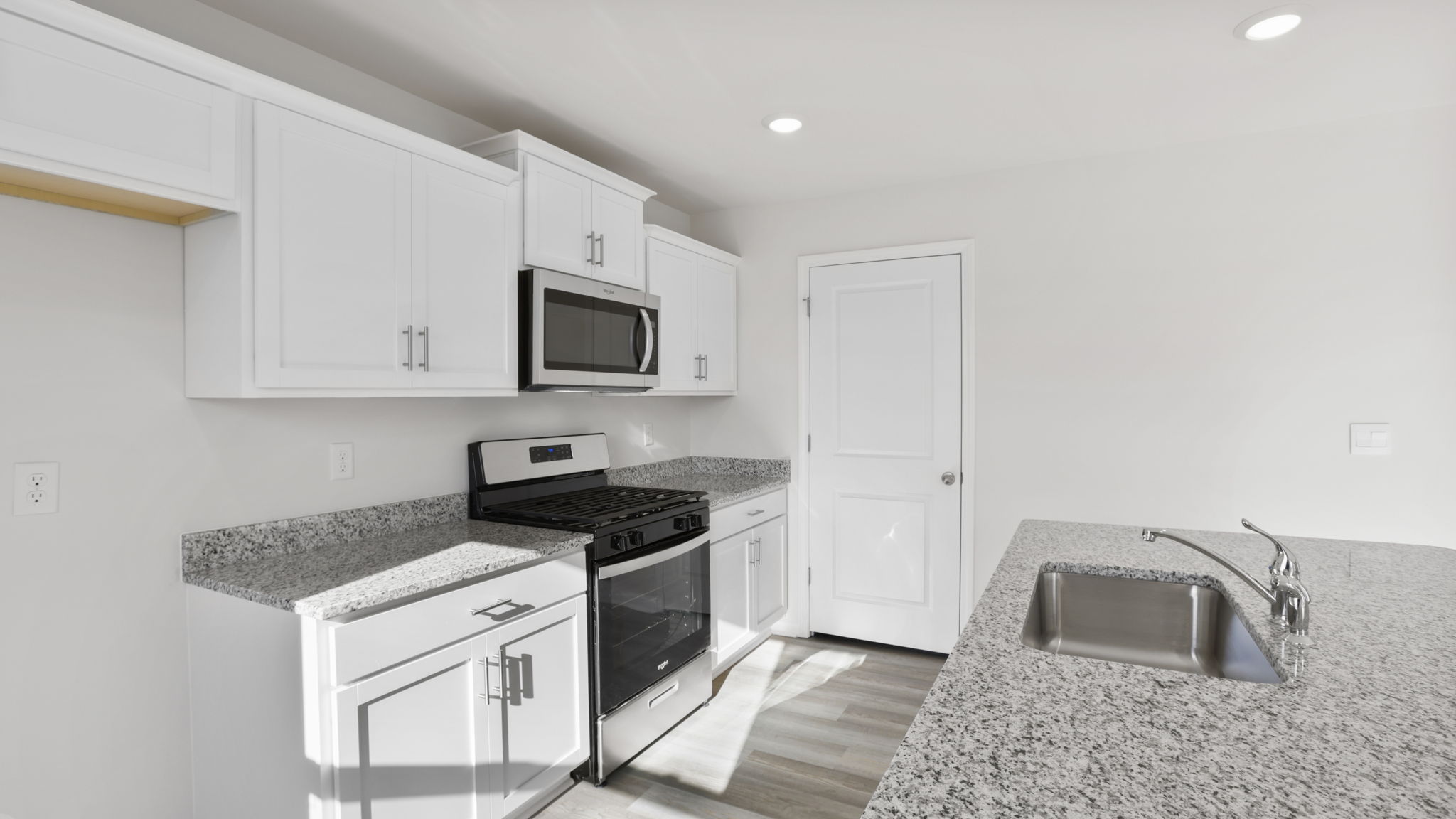 Kitchen and island with quartz counter tops.