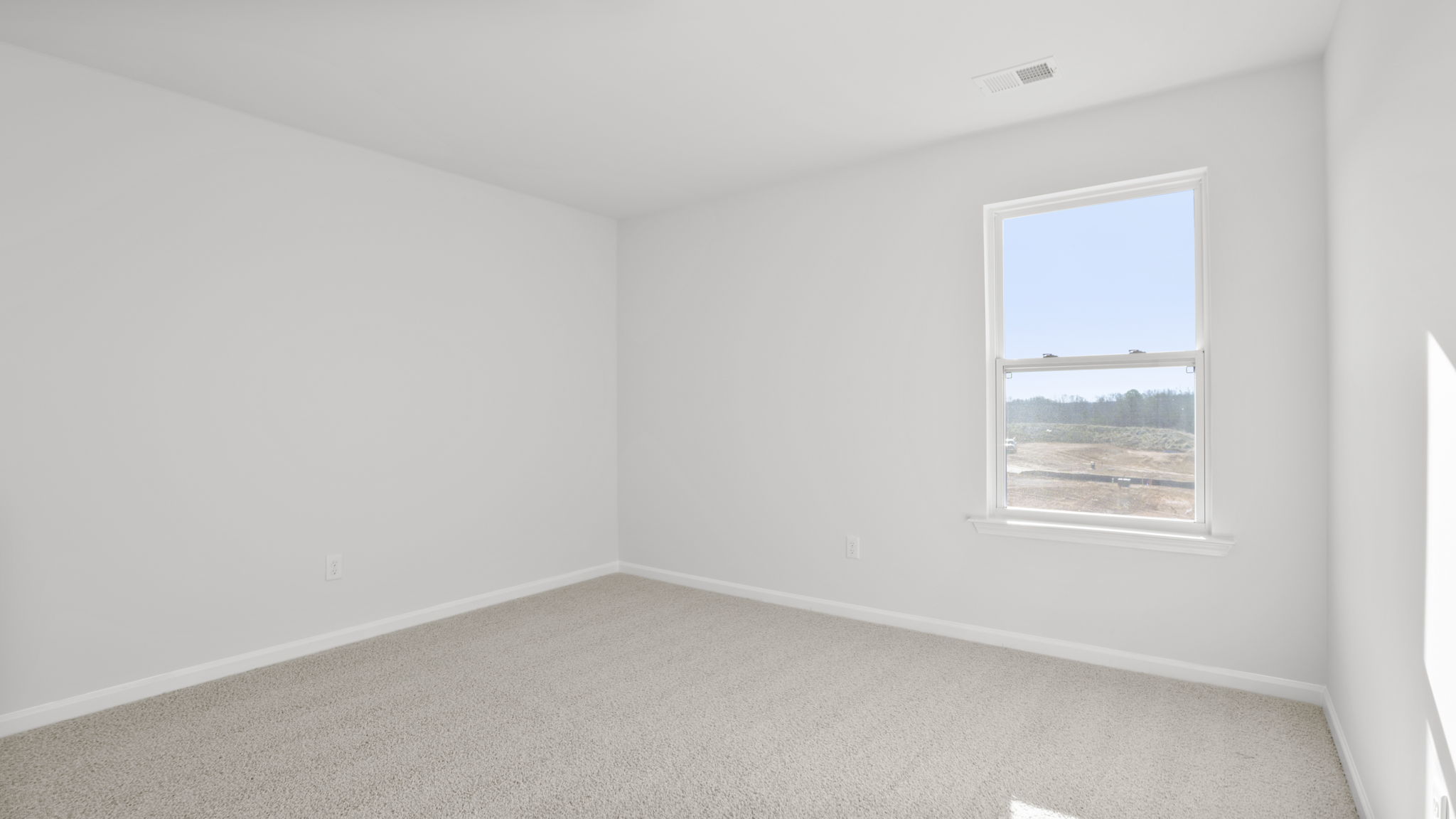 Bedroom with carpet and window.