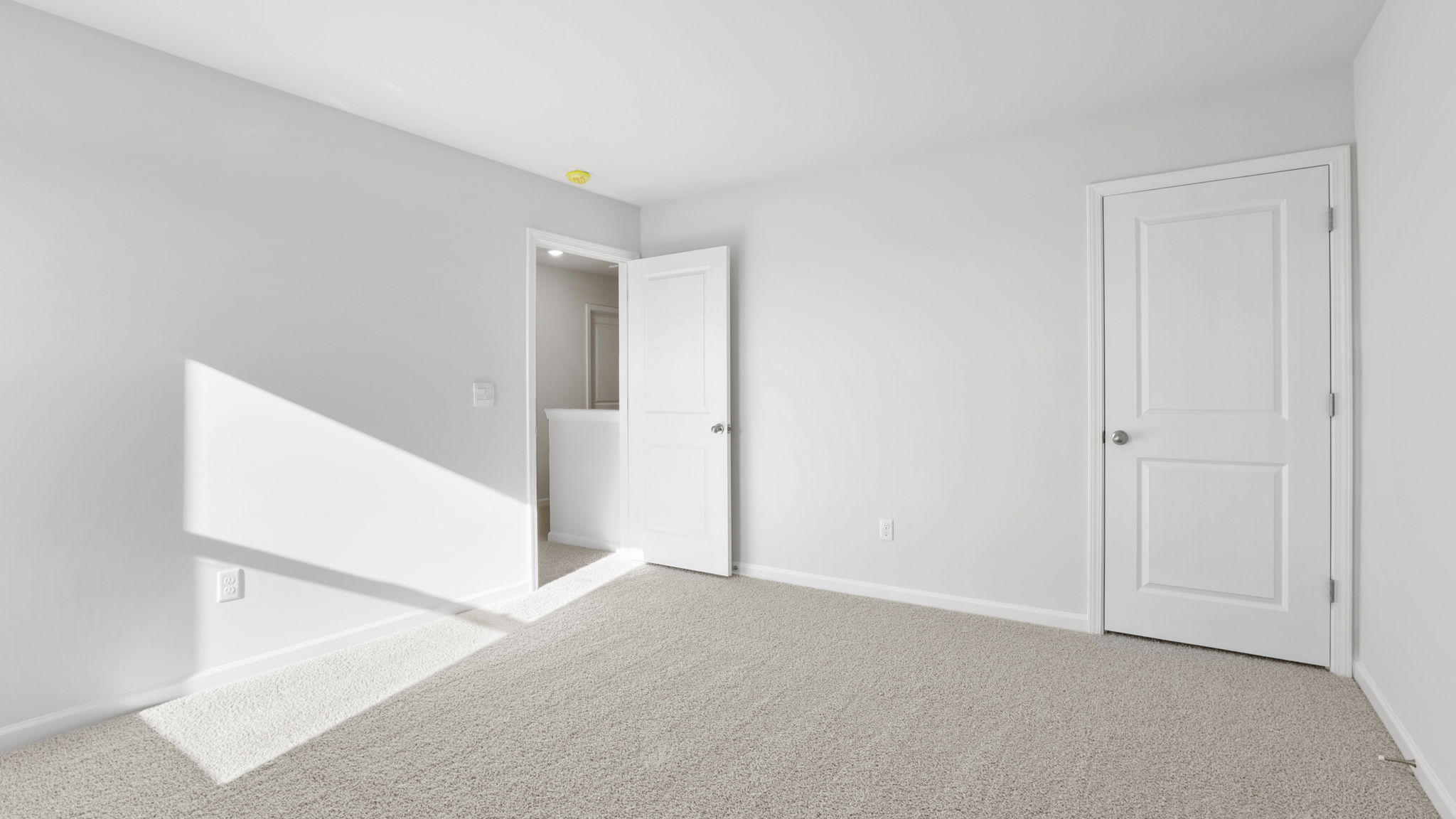 Bedroom with carpet and window.