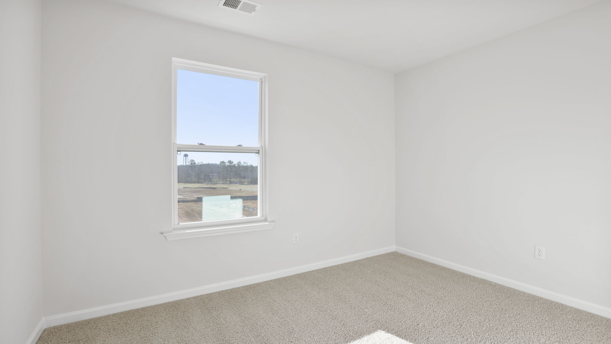 Bedroom with carpet and window.