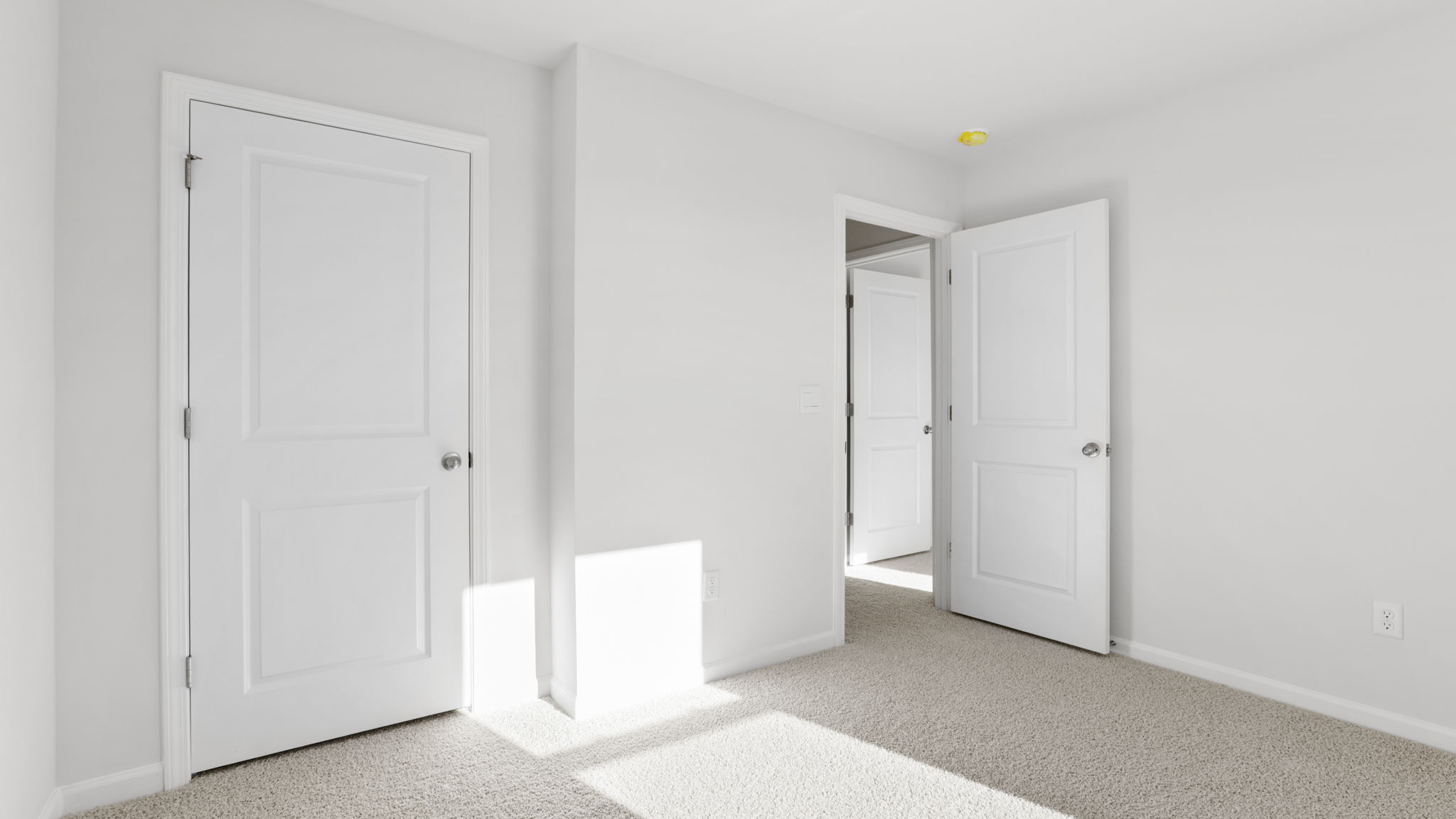 Bedroom with carpet and window.