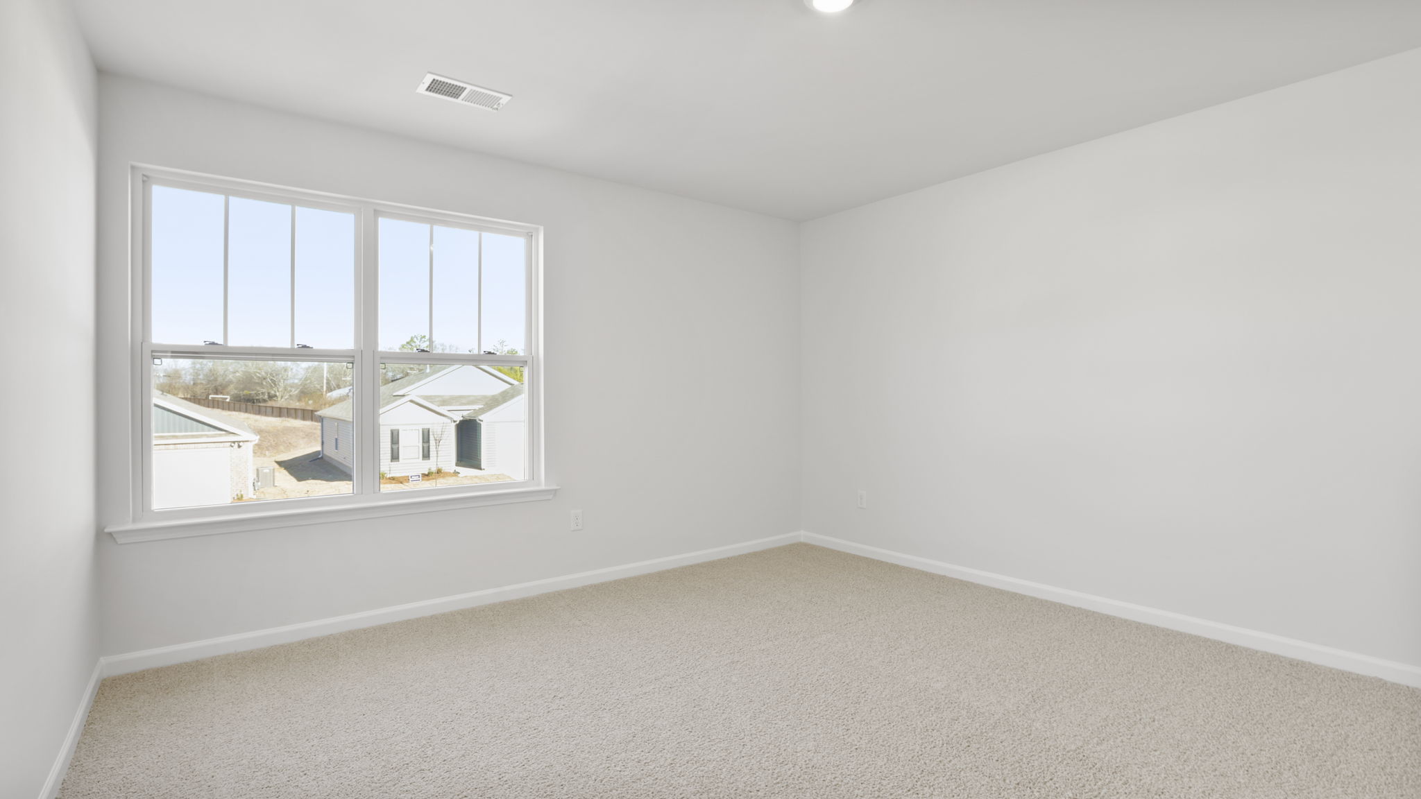 Bedroom with carpet and window.