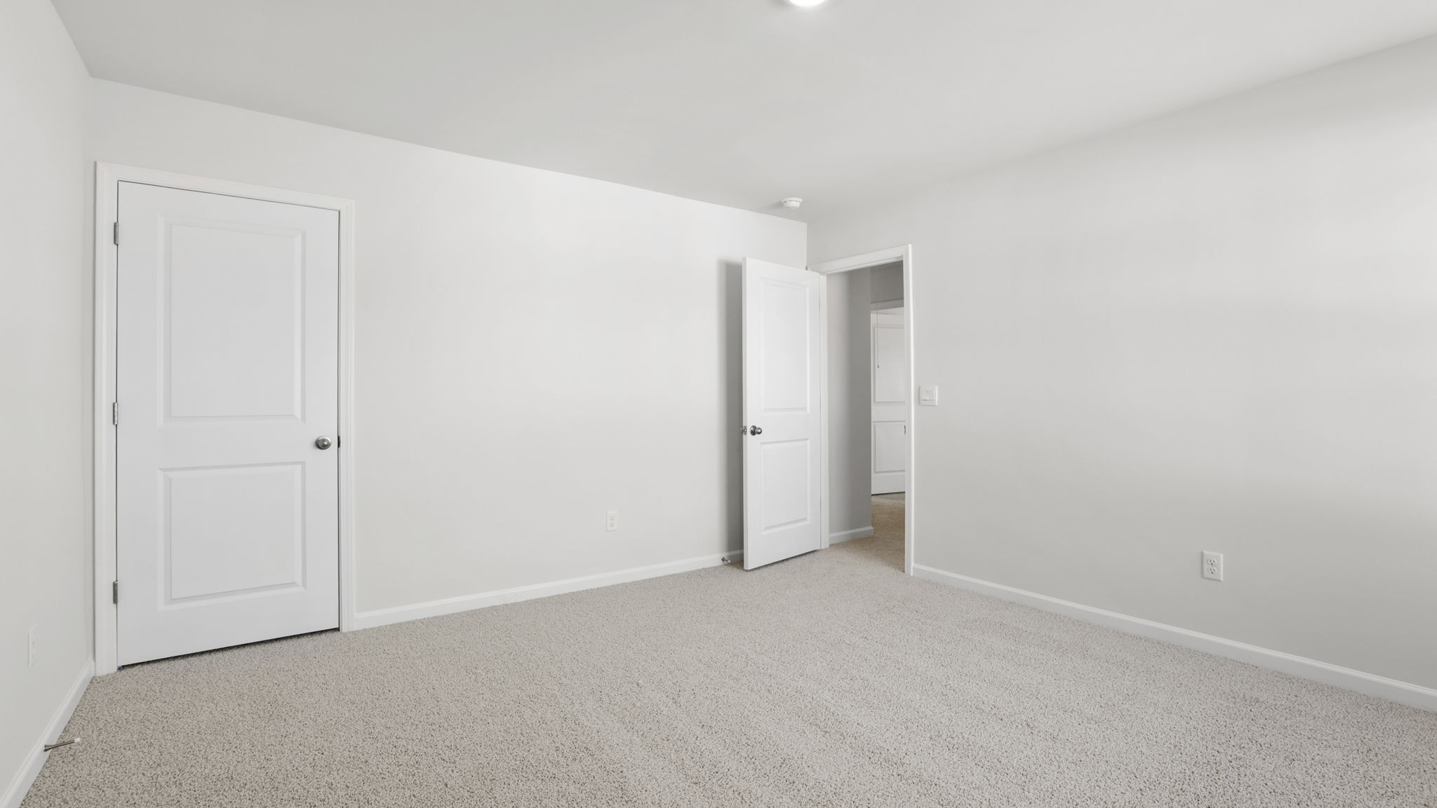 Bedroom with carpet and window.