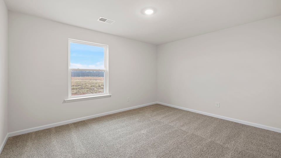 Bedroom with window and carpet.