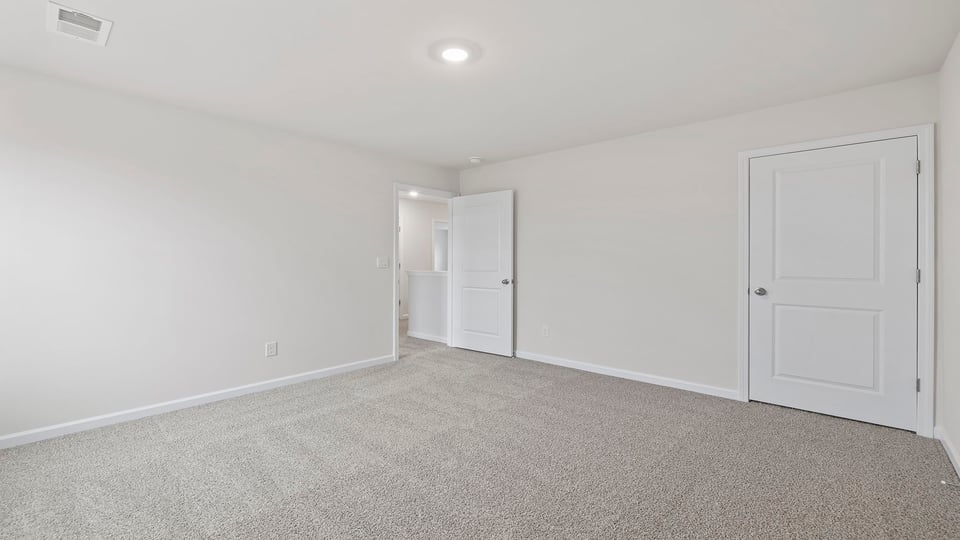Bedroom with window and carpet.