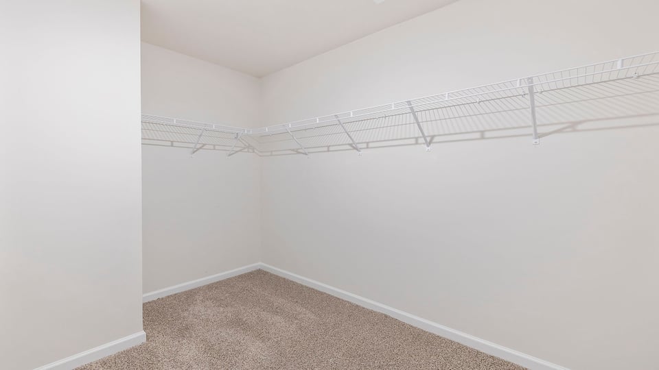 Primary bedroom walk-in closet.