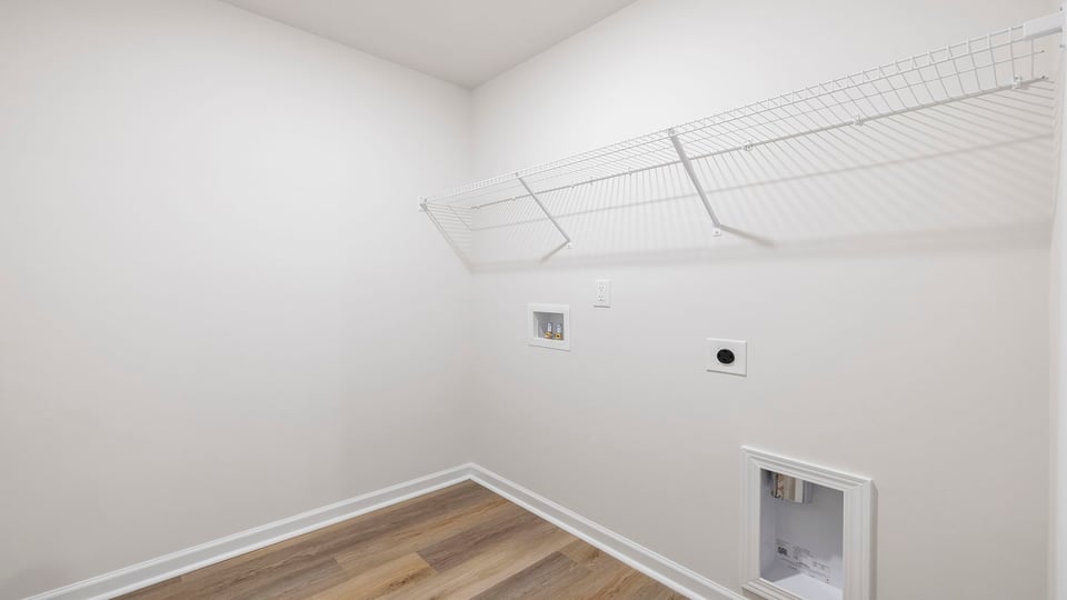 Walk-in laundry room with shelving.