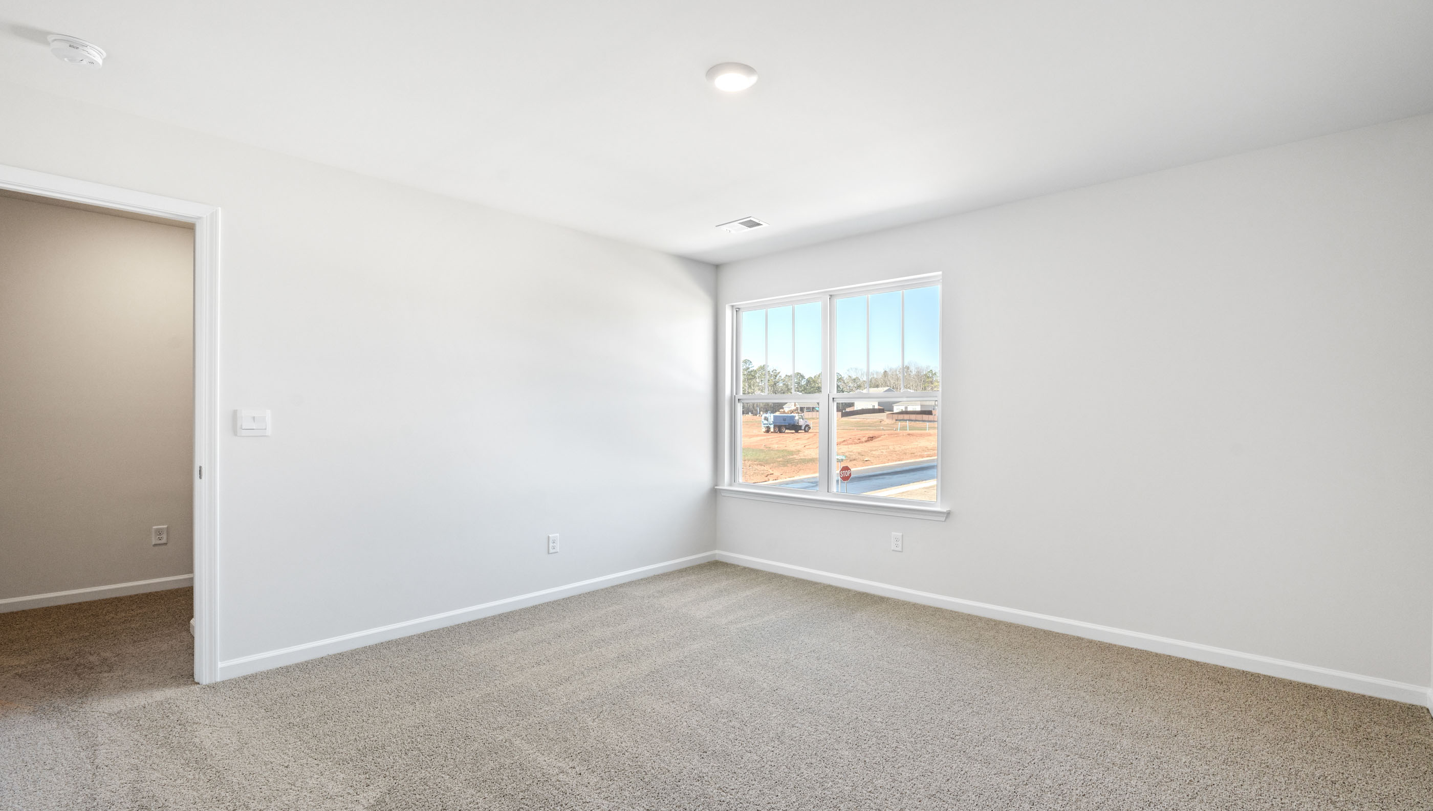 Bedroom with carpet and window.