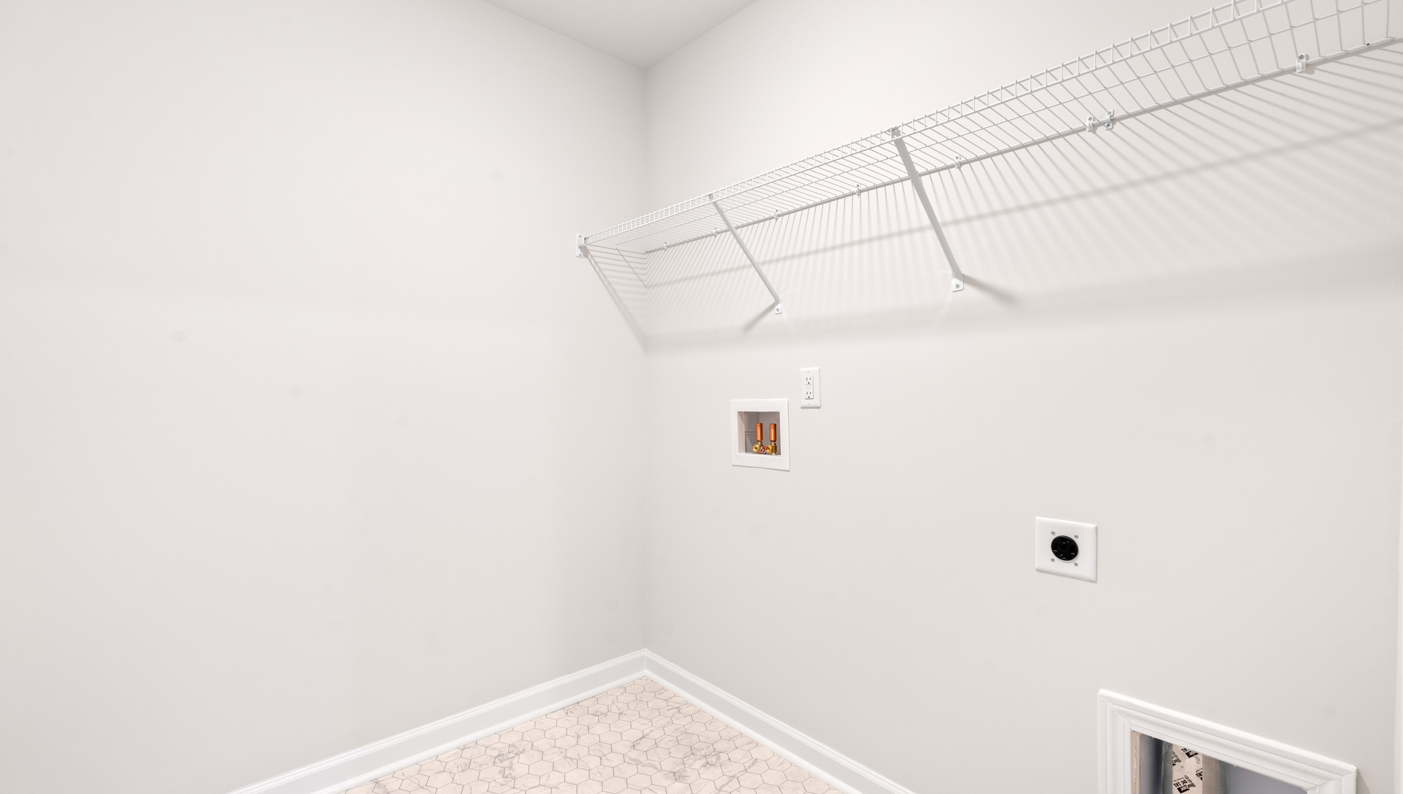 Laundry room with hanging storage racks.