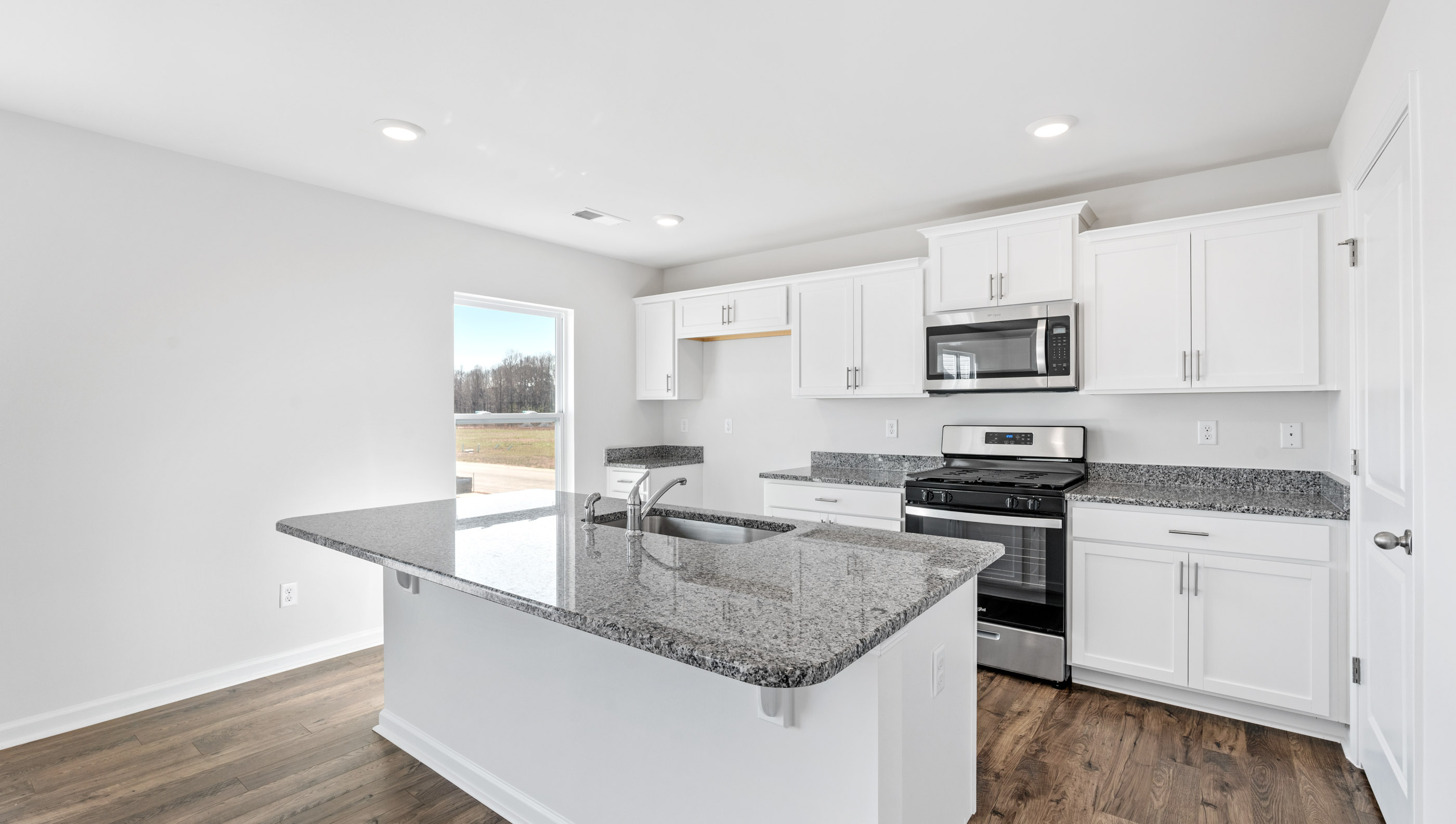 Kitchen and island with granite tops.