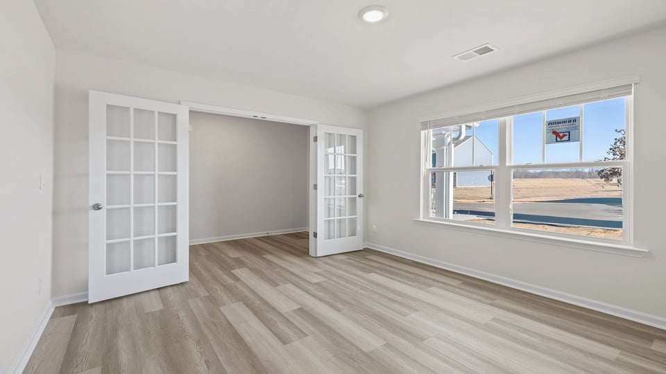 Study with large window and French doors.