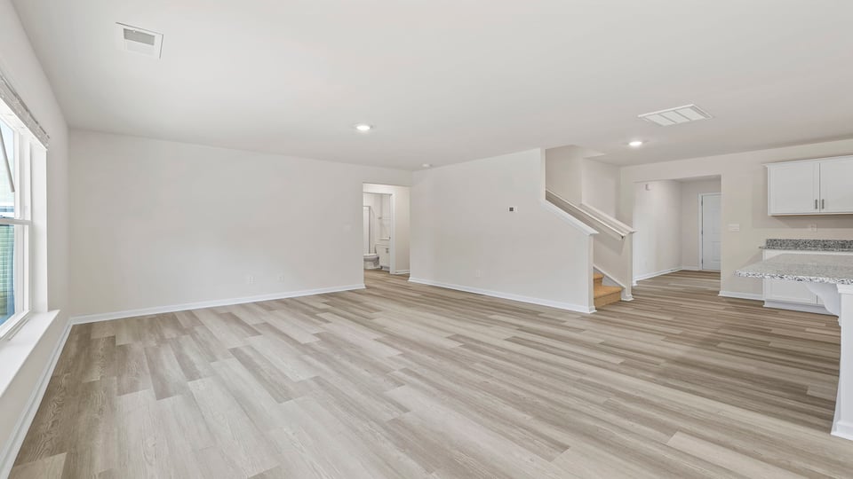 View of living area and kitchen.