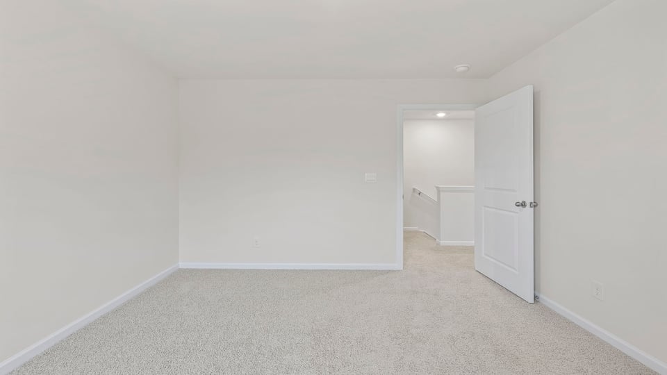 Bedroom with window and carpet.