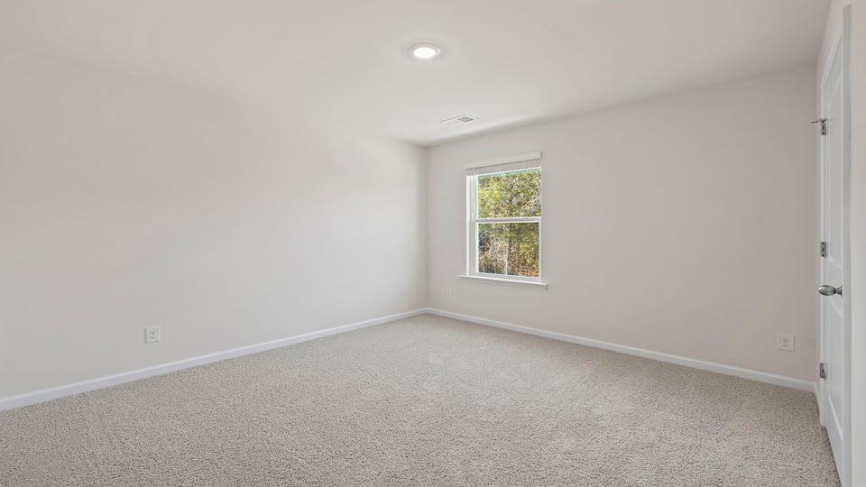 Bedroom with window and carpet.