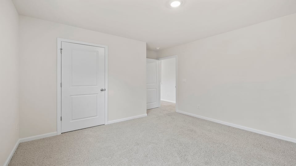 Bedroom with window and carpet.